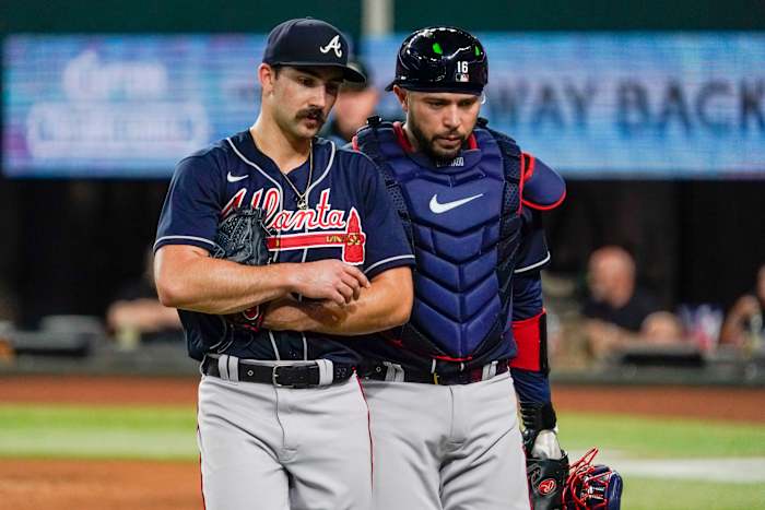 May 17, 2023; Arlington, Texas, USA; Atlanta Braves starting pitcher Spencer Strider (99) and catcher Travis d'Arnaud (16) talk on the way to the dugout after the third inning against the Texas Rangers at Globe Life Field. Mandatory Credit: Raymond Carlin III-USA TODAY Sports